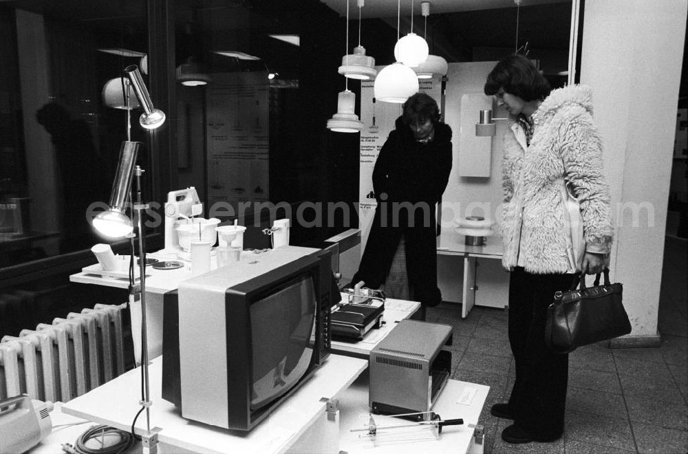 Berlin: Zwei Frauen besuchen die Bauausstellung im Ausstellungszentrum am Fuße des Berliner Fernsehturm und betrachten aufmerksam verschiedene elektronische Geräte wie z.B. einen Fernseher.