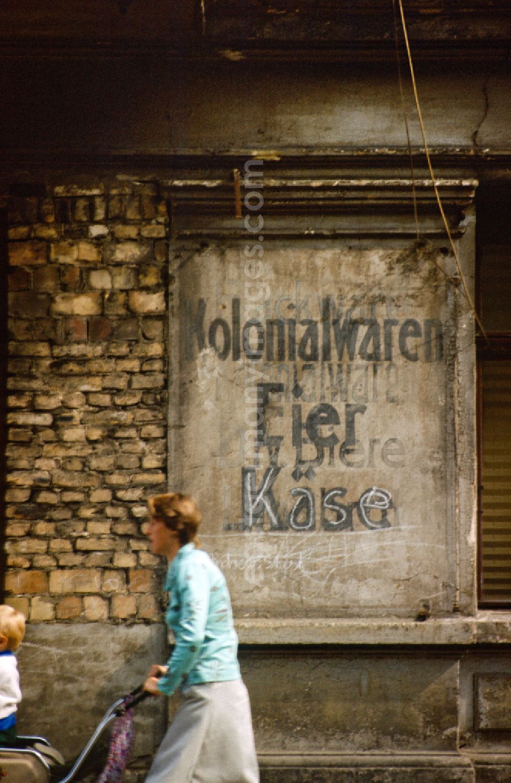 Berlin: Terms Colonial goods, eggs, beers and cheese on a house wall in East Berlin in the territory of the former GDR, German Democratic Republic