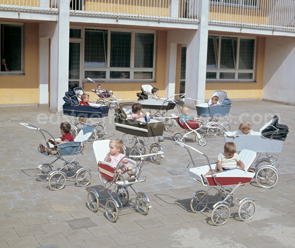 Berlin: Small children sit in a stroller in the yard of a daycare center in East Berlin in the territory of the former GDR, German Democratic Republic