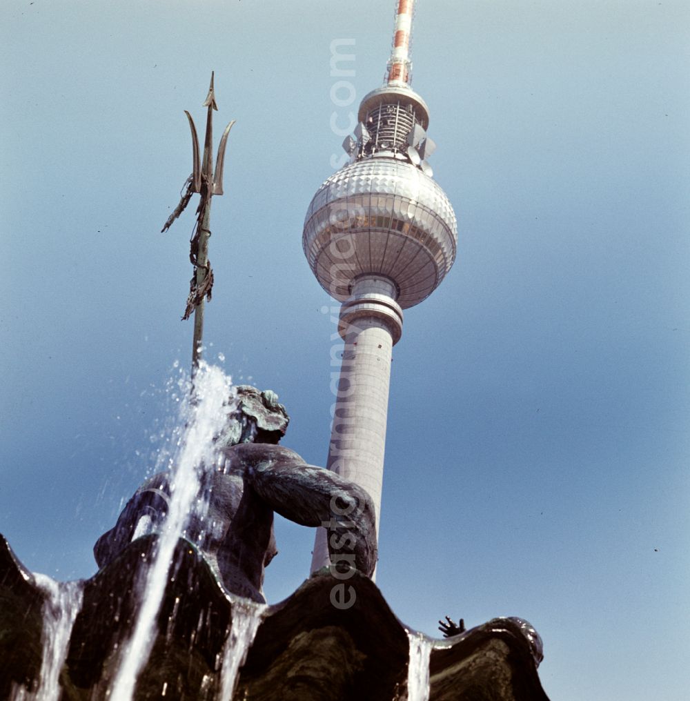 GDR photo archive: Berlin - Popular water feature - fountain Neptunbrunnen with a view of the Berlin TV tower on the Alexanderplatz in the Mitte district of Berlin East Berlin in the territory of the former GDR, German Democratic Republic