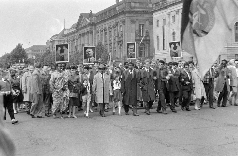 GDR image archive: Berlin - Participants of the May 1st demonstration with the portrait photos of Nikita Khrushchev and Otto Grothewohl on the streets of the city center on the B2 street in the Mitte district of Berlin East Berlin on the territory of the former GDR, German Democratic Republic