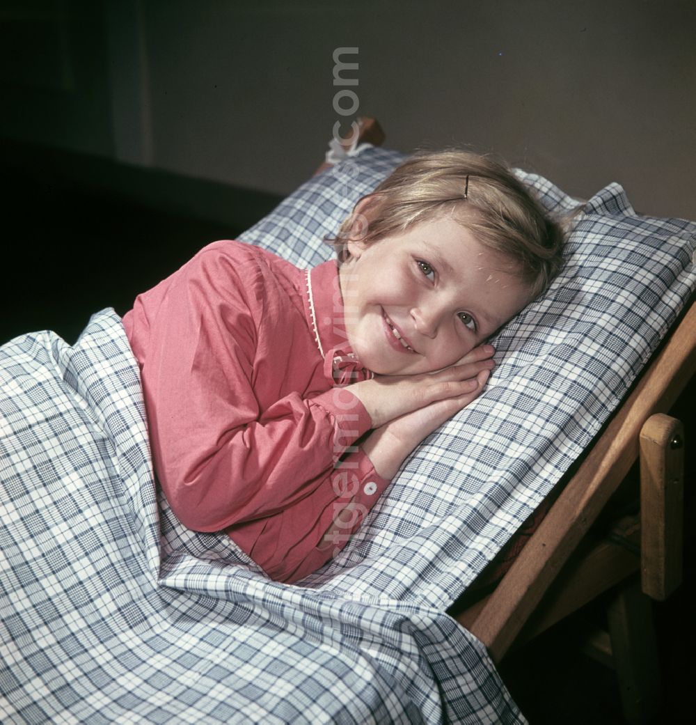 GDR photo archive: Berlin - A little girl taking a nap in the kindergarten on Michael-Brueckner-Strasse in the Schoeneweide district of Berlin in the territory of the former GDR, German Democratic Republic