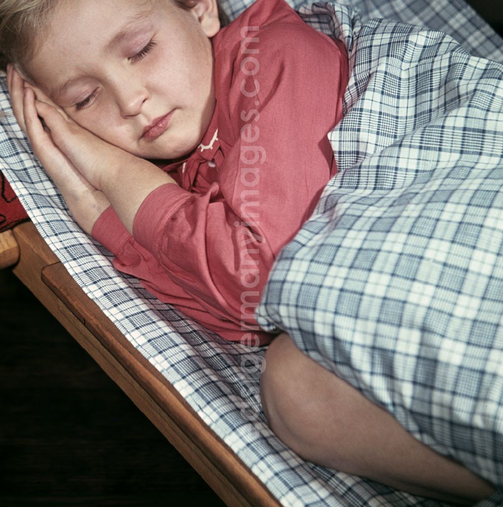 GDR picture archive: Berlin - A little girl taking a nap in the kindergarten on Michael-Brueckner-Strasse in the Schoeneweide district of Berlin in the territory of the former GDR, German Democratic Republic