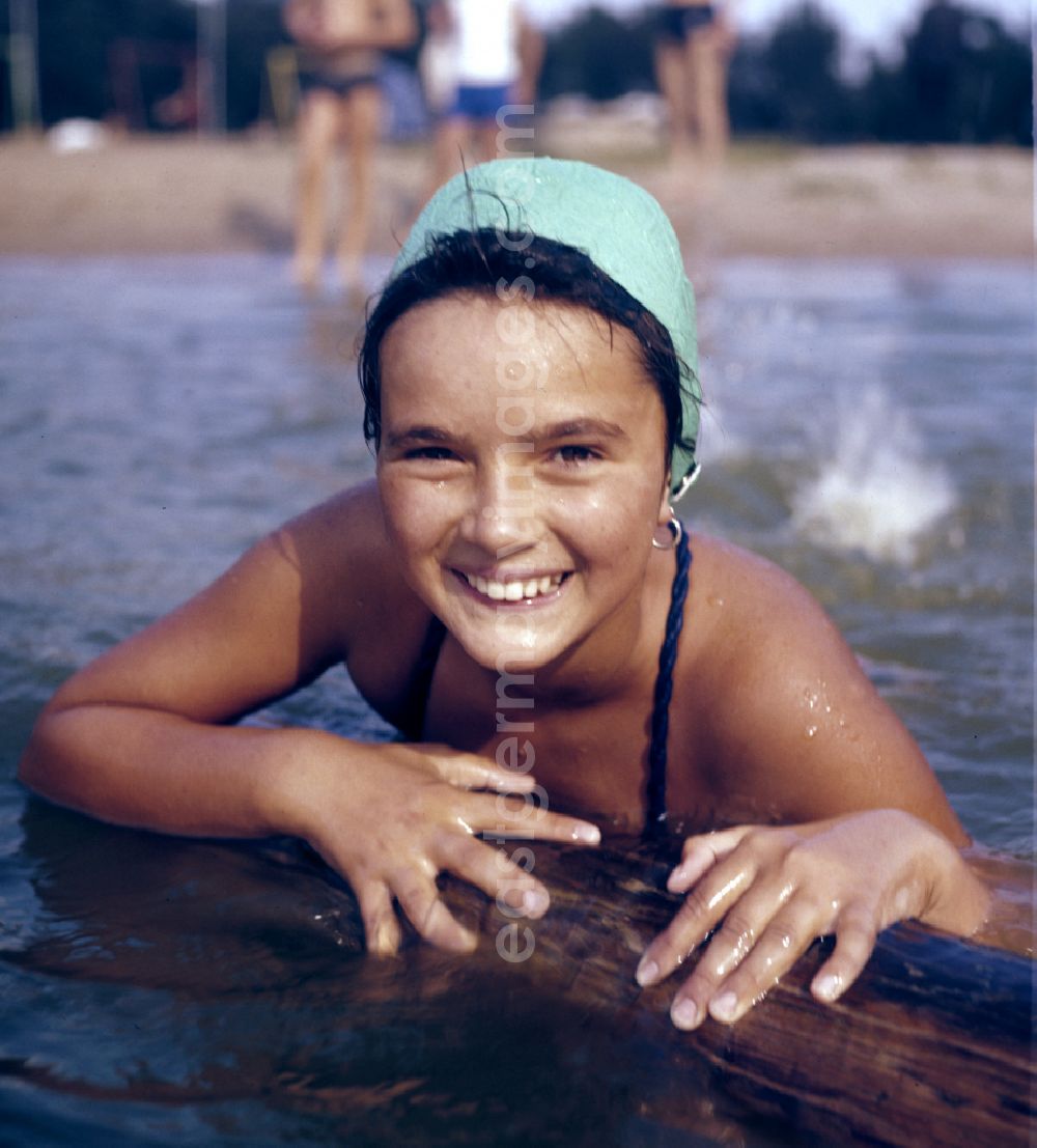 GDR photo archive: Berlin - A girl in a swimsuit and swimming cap at a lido on the street Sportpromenade in Berlin East Berlin in the territory of the former GDR, German Democratic Republic