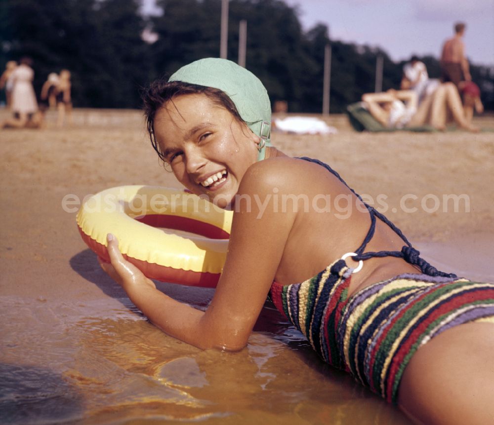 Berlin: A girl in a bathing suit, with a swimming cap and a swimming ring in a lido on the street Sportpromenade in Berlin East Berlin in the territory of the former GDR, German Democratic Republic