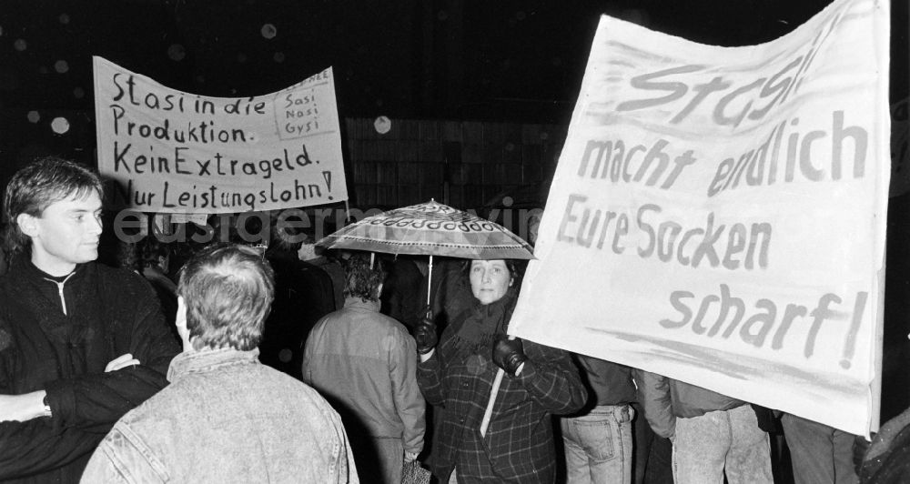 GDR photo archive: Berlin - Demonstrators and protesters during the storming and occupation the headquarters of the MfS Ministry for State Security on street Ruschestrasse - Normannenstrasse in the district Lichtenberg in Berlin Eastberlin on the territory of the former GDR, German Democratic Republic