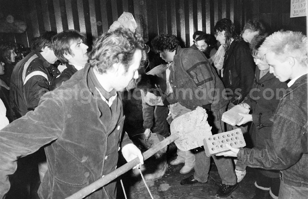 GDR photo archive: Berlin - Demonstrators and protesters during the storming and occupation the headquarters of the MfS Ministry for State Security on street Ruschestrasse - Normannenstrasse in the district Lichtenberg in Berlin Eastberlin on the territory of the former GDR, German Democratic Republic