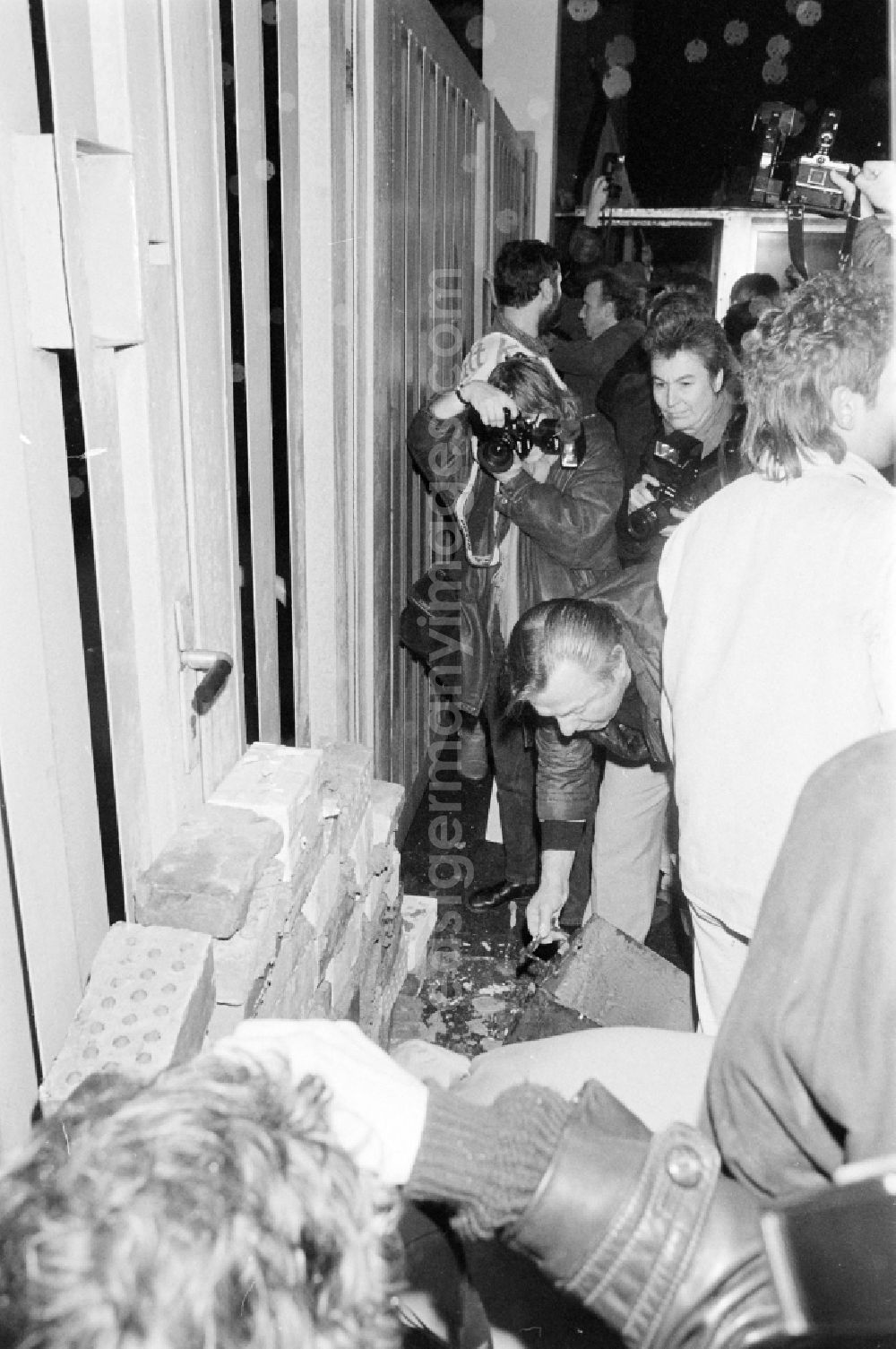 GDR photo archive: Berlin - Demonstrators and protesters during the storming and occupation the headquarters of the MfS Ministry for State Security on street Ruschestrasse - Normannenstrasse in the district Lichtenberg in Berlin Eastberlin on the territory of the former GDR, German Democratic Republic