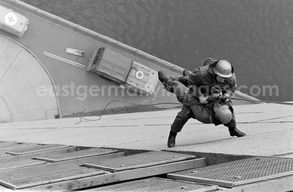 GDR image archive: Berlin - Fire brigade rescue exercise on the facade of a residential building in Fischerinsel Street in the Mitte district of East Berlin in the territory of the former GDR, German Democratic Republic