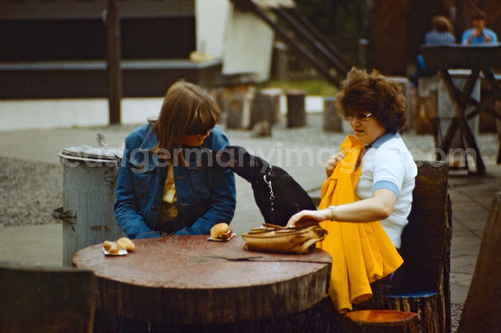 Berlin: Women eat a Bockwurst in East Berlin on the territory of the former GDR, German Democratic Republic