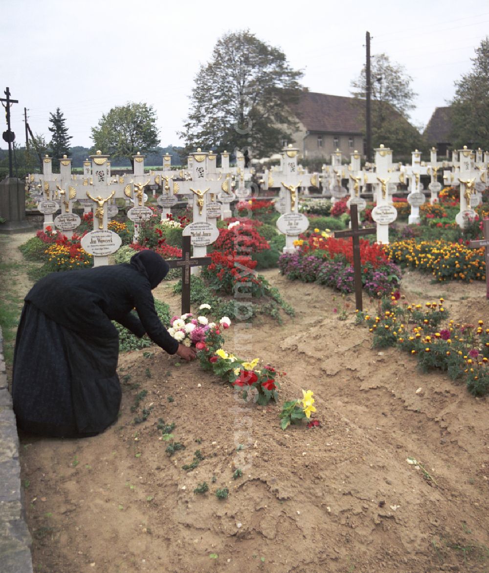 GDR photo archive: Ralbitz-Rosenthal - Cultural-historical grave cross and gravestone ensemble in the Sorbian cemetery on the main street in Ralbitz-Rosenthal, Saxony in the territory of the former GDR, German Democratic Republic