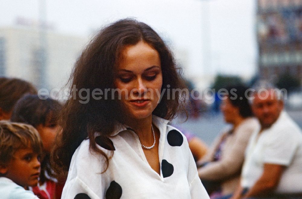 GDR photo archive: Berlin - Young woman on Alexanderplatz in East Berlin in the territory of the former GDR, German Democratic Republic