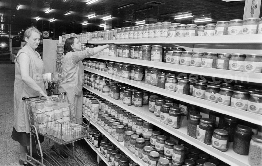 GDR photo archive: Berlin - Saleswomen stocking the shelves in the Kaufhalle shopping centre on Schoenhauser Allee in the Pankow district of Berlin, East Berlin, in the territory of the former GDR, German Democratic Republic