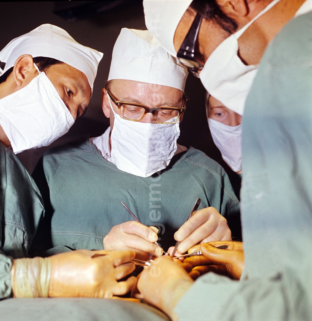 GDR picture archive: Berlin - Professor Dr. Hans Gummel providing patient care in a clinic by operating in an operating room Robert-Roessle-Klinik on Robert-Roessle-Strasse in the district of Buch in Berlin East Berlin in the area of the former GDR, German Democratic Republic