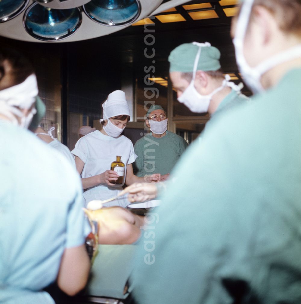 GDR image archive: Berlin - Professor Dr. Hans Gummel providing patient care in a clinic by operating in an operating room Robert-Roessle-Klinik on Robert-Roessle-Strasse in the district of Buch in Berlin East Berlin in the area of the former GDR, German Democratic Republic