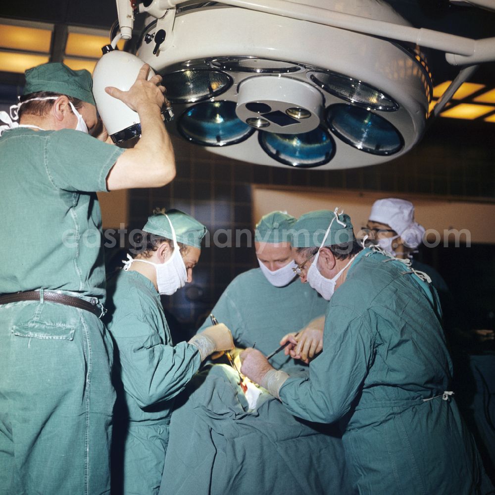 GDR picture archive: Berlin - Professor Dr. Hans Gummel providing patient care in a clinic by operating in an operating room Robert-Roessle-Klinik on Robert-Roessle-Strasse in the district of Buch in Berlin East Berlin in the area of the former GDR, German Democratic Republic