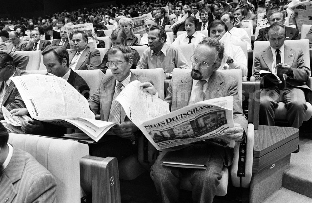 GDR picture archive: Berlin - Short break with a quick look at the newspaper Neues Deutschland as the central organ of the SED at the conference for the 7th Building Conference in the Great Hall of the Palace of the Republic in the Mitte district of Berlin, East Berlin on the territory of the former GDR, German Democratic Republic