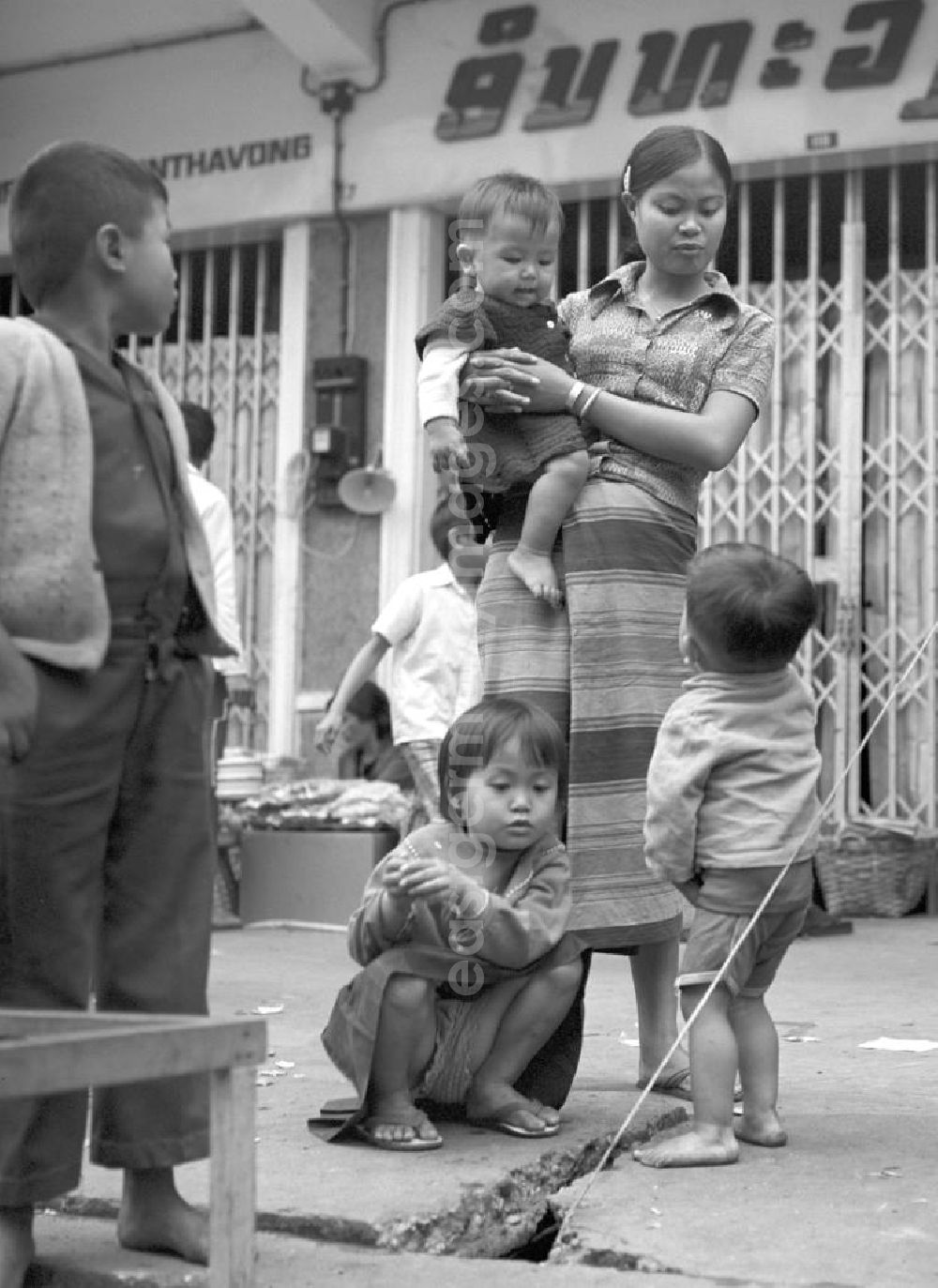 GDR picture archive: Vientiane - Eine Frau mit ihren Kindern auf einer Straße in Vientiane, der Hauptstadt der Demokratischen Volksrepublik Laos.
