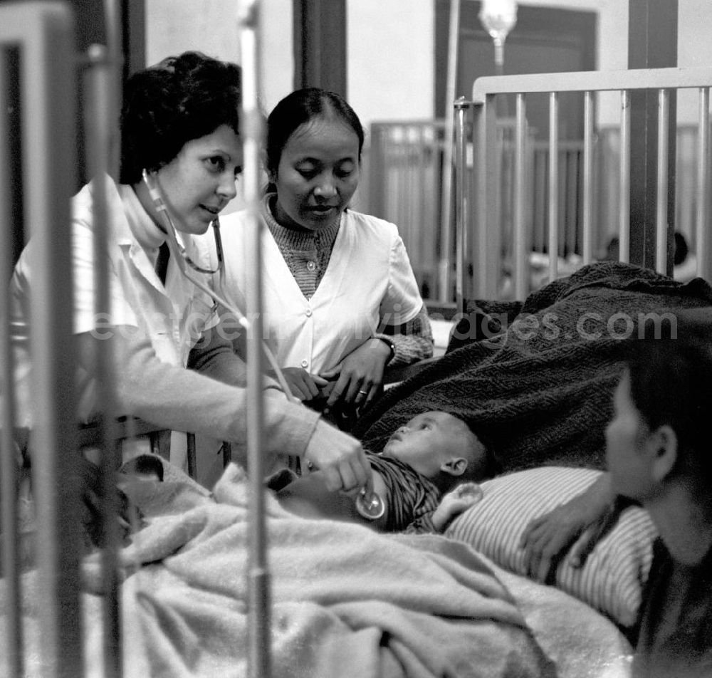 GDR picture archive: Vientiane - Eine kubanische Ärztin untersucht ein laotisches Kind in einem laotischen Krankenhaus in der Demokratischen Volksrepublik Laos.