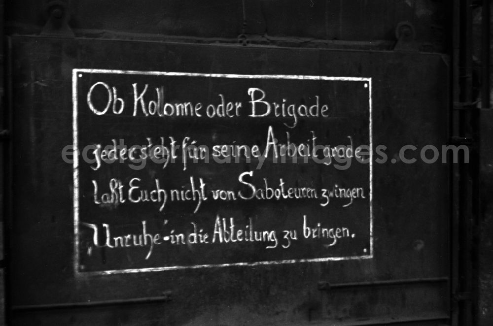 GDR photo archive: Bautzen - The inscription Whether column or brigade, everyone is responsible for their work, do not let saboteurs force you to bring unrest into the department hangs in the workshop of the Association of People’sOwned Enterprises of Locomotive and Wagon Construction (VVB LOWA) in Bautzen, Saxony in the territory of the former GDR, German Democratic Republic