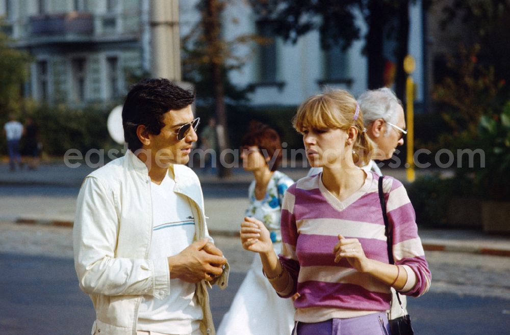 GDR photo archive: Berlin - Man and woman in conversation in East Berlin on the territory of the former GDR, German Democratic Republic