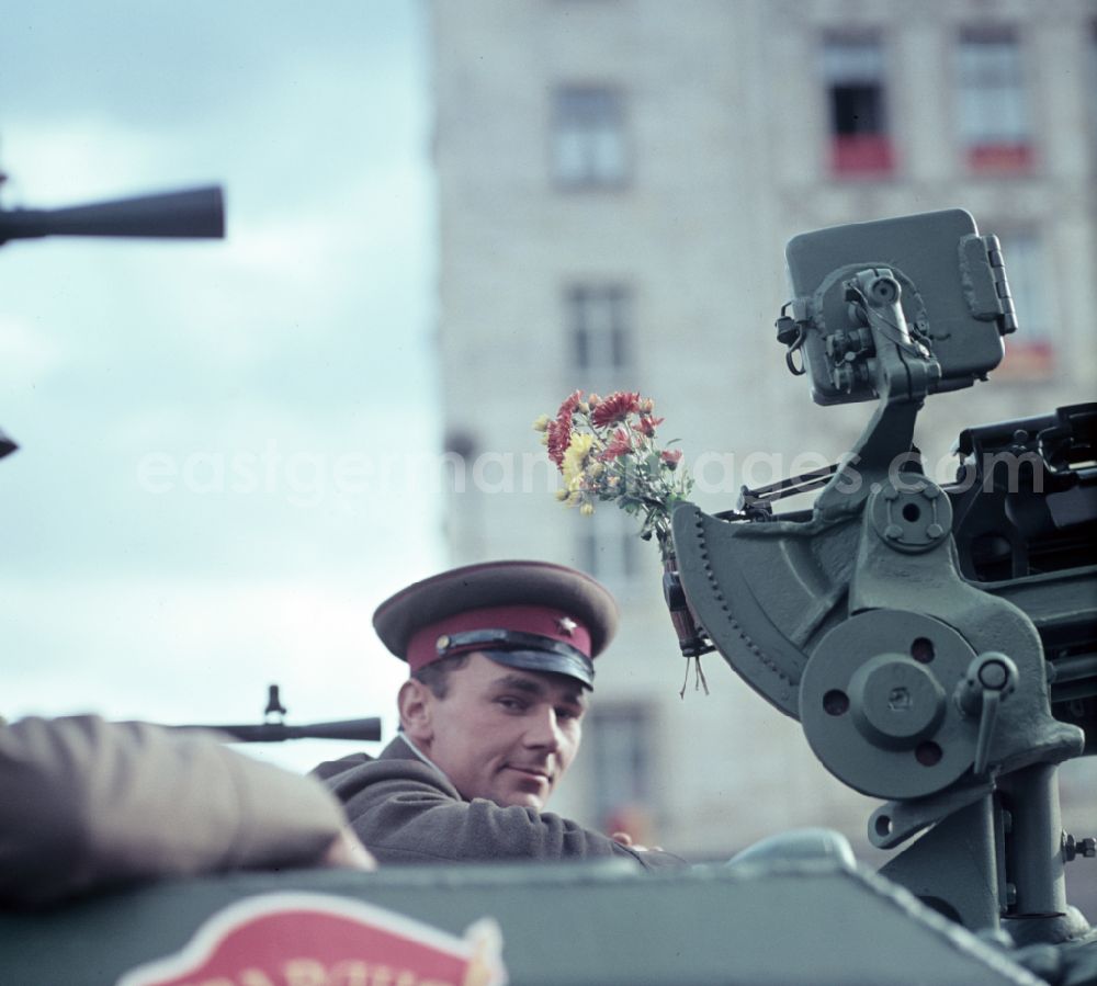 Berlin: Enthusiastic population forming a guard of honor for the parade drive of military and combat technology Armored infantry vehicle SPW BRDM-1 on Lichtenberger Strasse in the district of Friedrichshain in East Berlin in the territory of the former GDR, German Democratic Republic