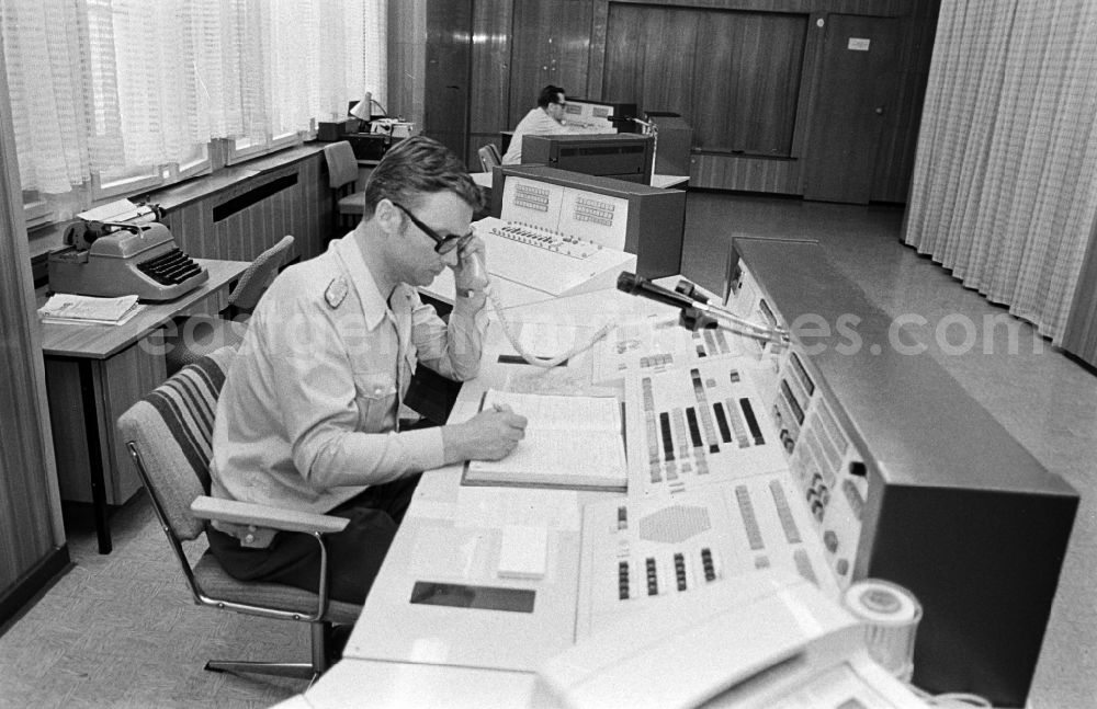 GDR photo archive: Berlin - Police officer in uniformin Uniform der Deutschen Volkspolizei im Lagezentrum on street Keibelstrasse in the district Mitte in Berlin Eastberlin on the territory of the former GDR, German Democratic Republic