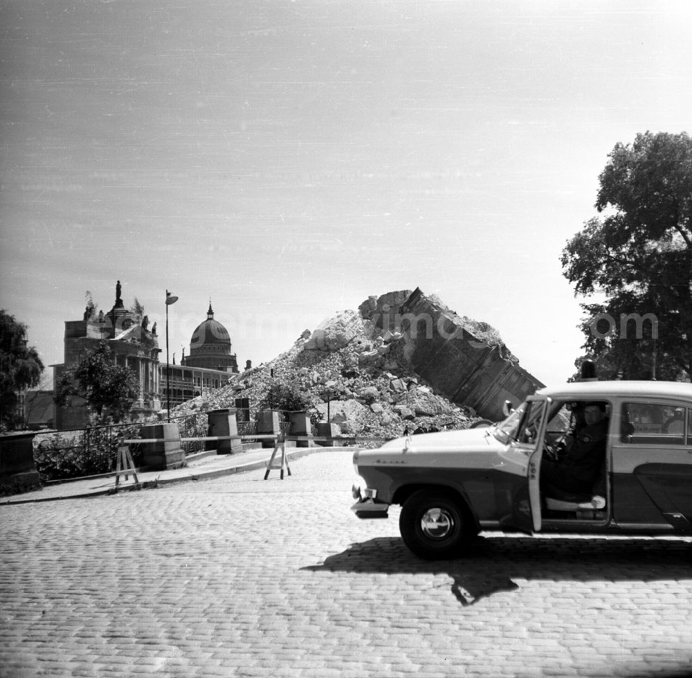 GDR photo archive: Potsdam - Ruins Remains of the facade and roof structure of the Potsdam Garrison Church after the bell tower was blown up on Breite Strasse in the inner city district of Potsdam, Brandenburg in the area of the former GDR, German Democratic Republic. In the foreground a GAZ M-21 Volga car of the German People's Police. The photographer was temporarily arrested for taking this photo, his personal details were taken and film and camera were confiscated - which was later returned to him without further comment