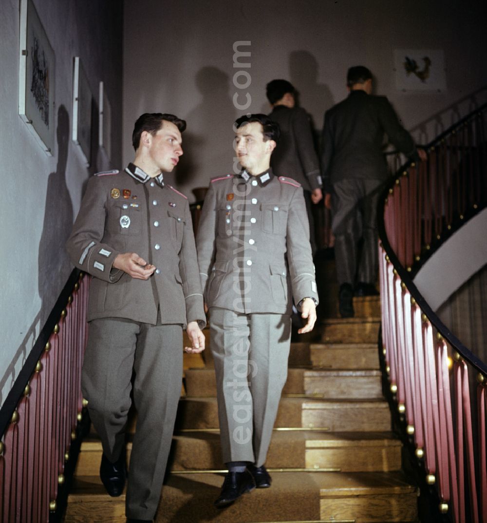 GDR picture archive: Oranienburg - Soldiers - equipment and uniforms of the land forces of the NVA National Peoples Army in their free time reading the newspaper and drinking beer in the common room in a barracks accommodation in Oranienburg, Brandenburg in the territory of the former GDR, German Democratic Republic