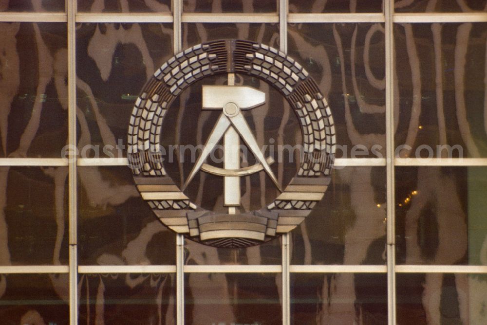 Berlin: State coat of arms of the GDR, consisting of a wreath of ears of corn, hammer and compass, on the facade of the Palace of the Republic in East Berlin on the territory of the former GDR, German Democratic Republic