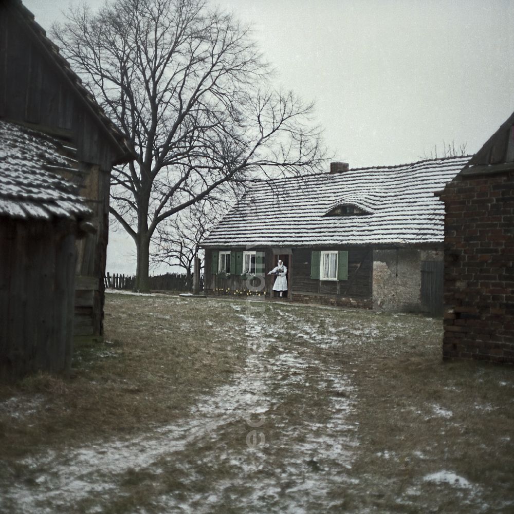 Kreba-Neudorf: Scene from the film and television production Continent Hope with the actress Majka Kowarjec in Sorbian costume as a mother in front of an old farm in Kreba-Neudorf, Saxony in the area of the former GDR, German Democratic Republic