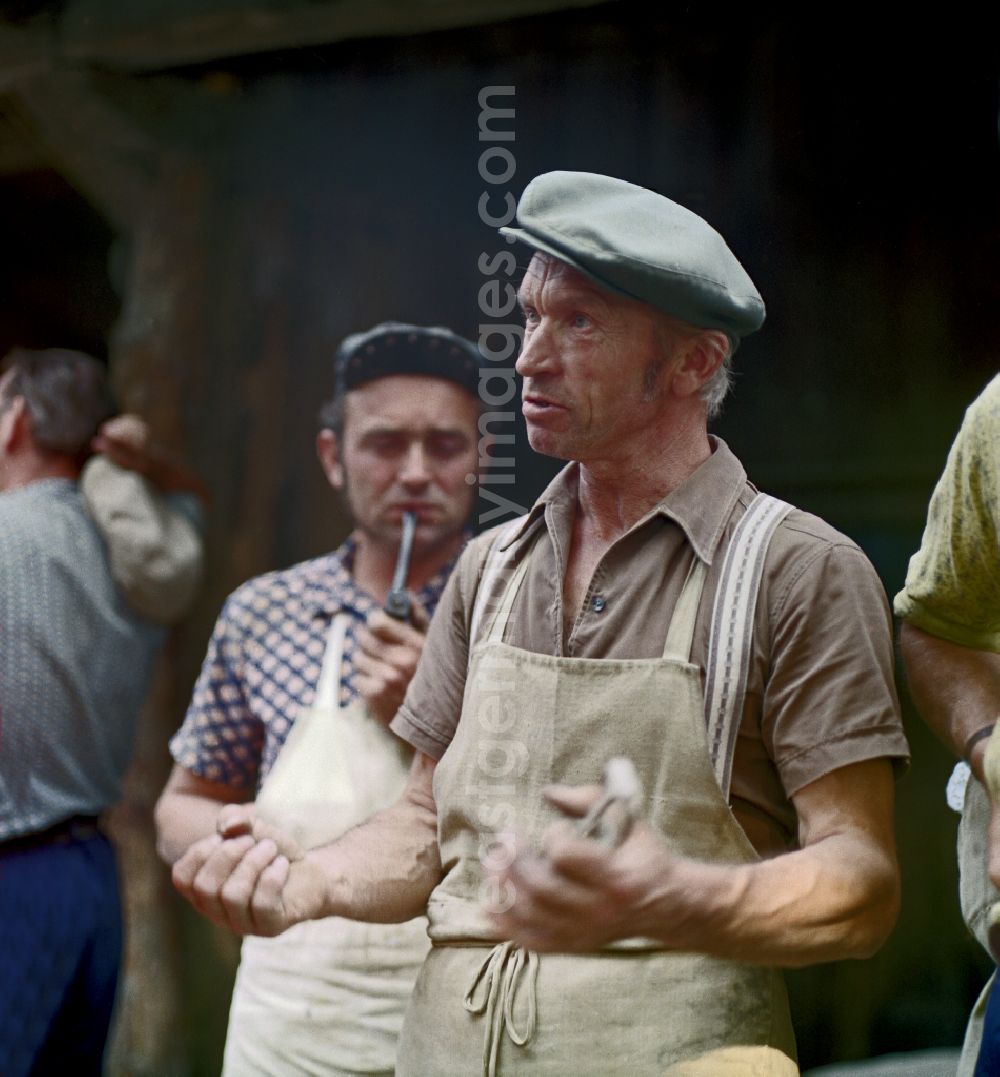 Horka: Quarry workers as a scene from the film and television production Portrait of a Center on the main street in Horka, Saxony in the area of the former GDR, German Democratic Republic