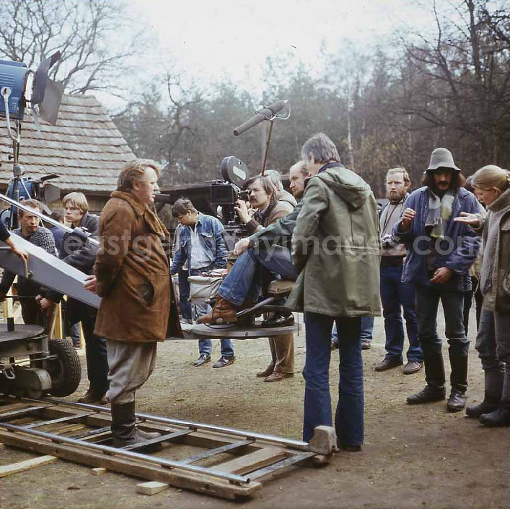 GDR photo archive: Weißkeißel - Scene from the film and television production Rublak - The Legend of the Surveyed Land in Weisskeissel, Saxony in the area of the former GDR, German Democratic Republic. The cameraman Lutz Koerner is filming the actor Kurt Boewe from a crane that is standing on rails. The director Konrad Herrmann and members of the film crew are standing behind him