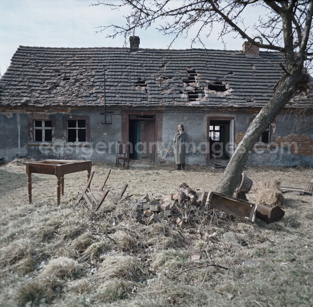 GDR picture archive: Spremberg - Scene from the film and television production Rublak - The Legend of the Surveyed Land Waste Landscape in Lusatia - the actor Christian Grashof at the destroyed entrance of a cleared farmhouse in Spremberg in the GDR