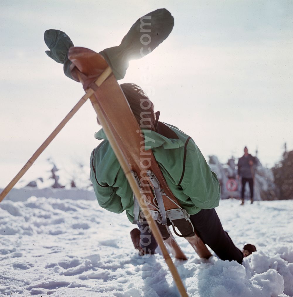 GDR photo archive: Bad Tabarz - Sunbathing on skis on the Grosser Inselsberg with transmission tower in winter in Bad Tabarz, Thuringia in the territory of the former GDR, German Democratic Republic