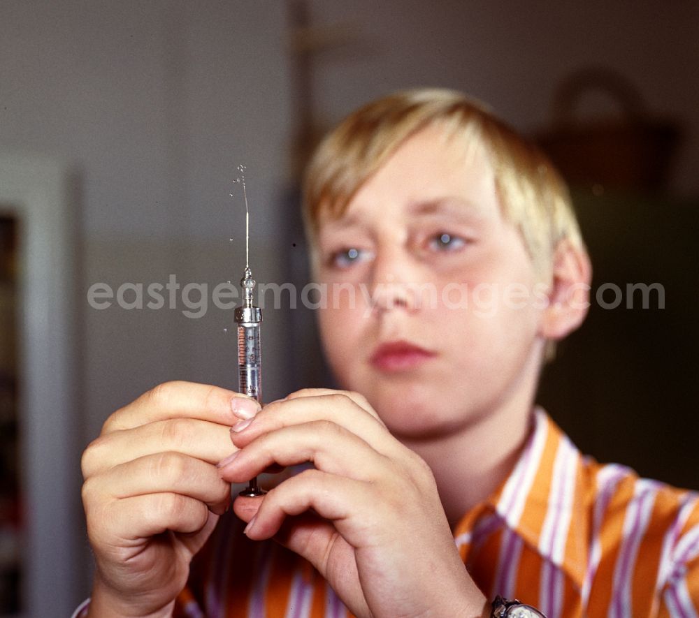 GDR picture archive: Karlsburg - A boy prepares his insulin injection at the Central Institute for Diabetes Gerhardt Katsch in Karlsburg, Mecklenburg-Vorpommern in the territory of the former GDR, German Democratic Republic