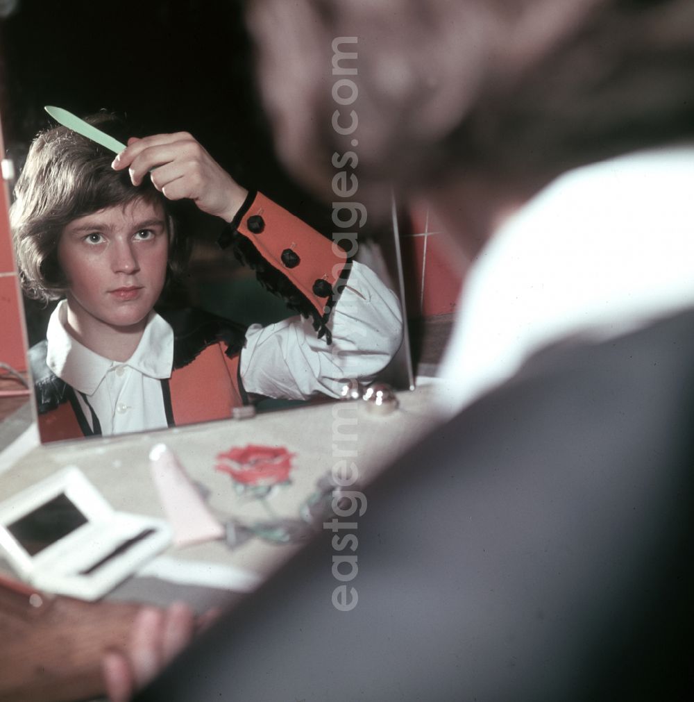 Berlin: Young artist combing his hair in front of the mirror in preparation for his performance at the Circus Busch in East Berlin, part of the former GDR, German Democratic Republic