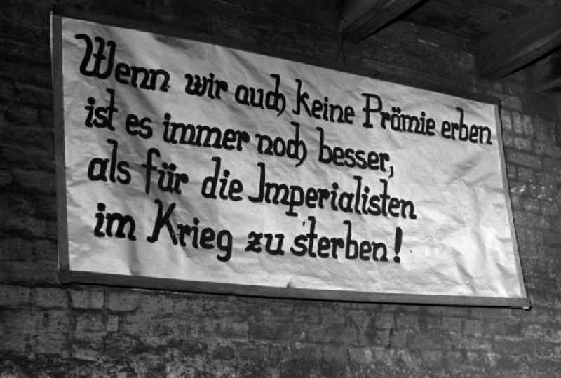 The inscription 'Even if we don't inherit a bonus, it is still better than dying in war for the imperialists!' hangs in the workshop of the Association of People's Owned Enterprises for Locomotive and Wagon Construction (VVB LOWA) in Bautzen, Saxony in the territory of the former GDR, German Democratic Republic