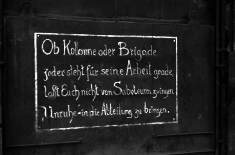 The inscription 'Whether column or brigade, everyone is responsible for their work, do not let saboteurs force you to bring unrest into the department' hangs in the workshop of the Association of People’sOwned Enterprises of Locomotive and Wagon Construction (VVB LOWA) in Bautzen, Saxony in the territory of the former GDR, German Democratic Republic