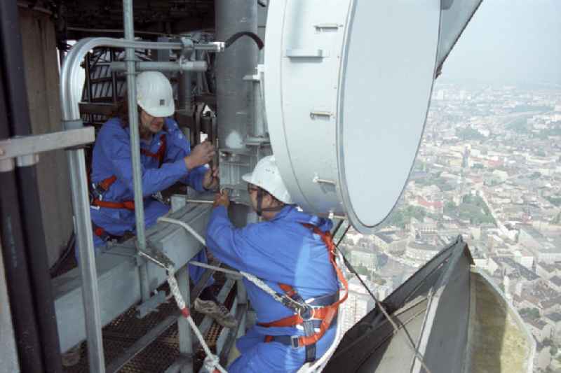 Technicians during maintenance and repair work during external work on the antenna support of the Berlin TV tower in the Mitte district of Berlin East Berlin