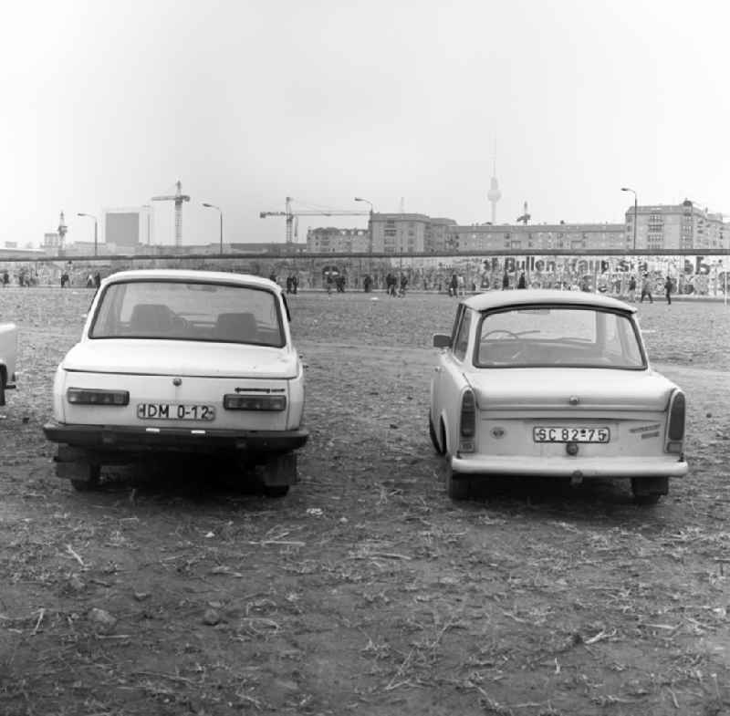 View over cars of type Wartburg and Trabant also called Trabi on the Potsdamer Platz in Berlin in the direction of the Berlin Wall, residential buildings, and TV Tower in East Berlin