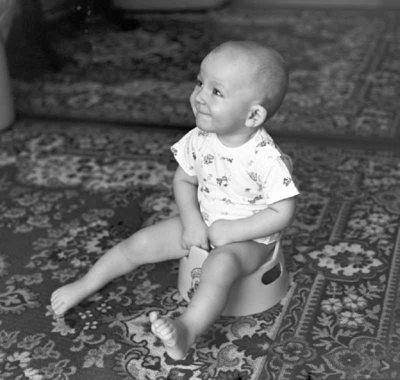 Little child sitting on a potty in Berlin