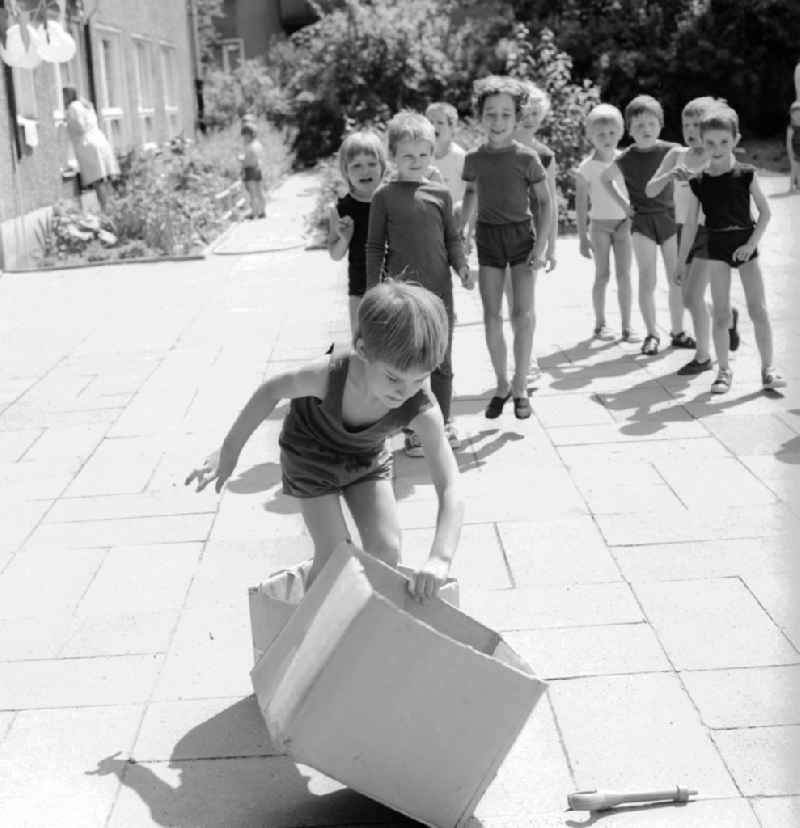 Children celebrate the International Children's Day at a preschool in Berlin, the former capital of the GDR, German Democratic Republic. On this day there was always a festive program which consisted of sport and play. Here at the box steeplechase