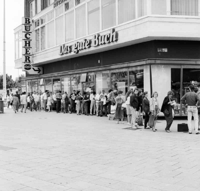 GDR citizens are facing a savings bank line to cash out the new D-mark that since the implementation of economic and monetary and social union, the East German marks replaced in Berlin, the former capital of the GDR, German Democratic Republic