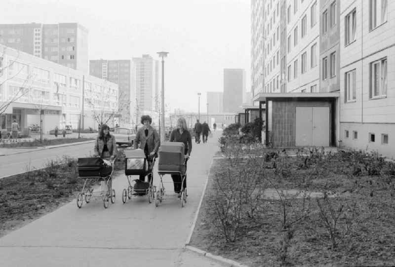 Three mothers by baby carriage in Berlin, the former capital of the GDR, German democratic republic