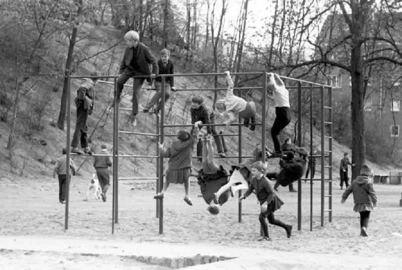 Children playing on a climbing scaffold on a playground in Berlin, the former capital of the GDR, German Democratic Republic