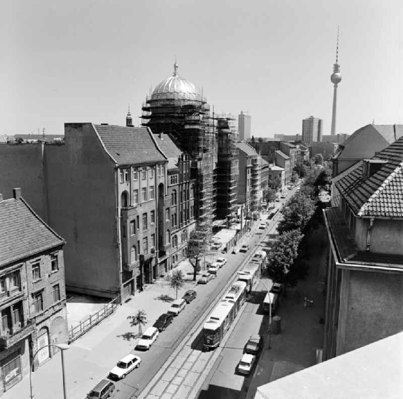 View of the Oranienburger Strasse towards the city center with New Synagogue during the construction works and TV tower in the background in Berlin - Mitte, the former capital of the GDR, German Democratic Republic