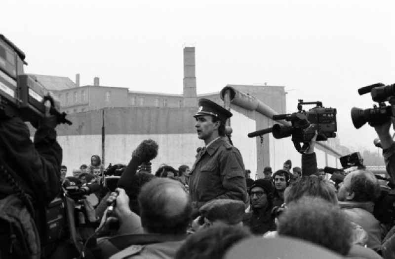 Border soldier speaks to everyone during the opening of the border at Potsdamer Platz in the district Mitte in Berlin, the former capital of the GDR, German Democratic Republic