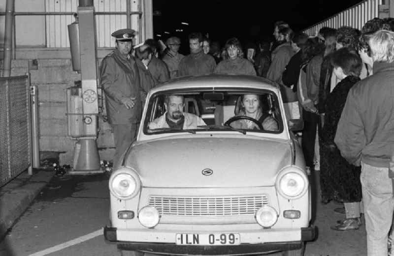 On the evening of the fall of the Berlin Wall, a Trabant car drives from East Berlin to West Berlin at the border crossing point Invalidenstrasse in the district Mitte in Berlin, the former capital of the GDR, German Democratic Republic