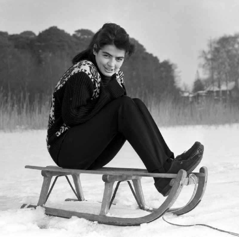 The actress Kati Szekely (Catherine Székely) with a sledge in winter in Berlin, the former capital of the GDR, German Democratic Republic